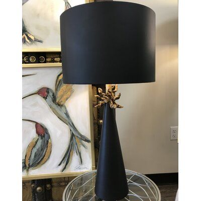 This Harpreet 29" table lamp works great alone or as a pair. Designed the drum shade to have a distressed gold leaf finish on the inside of the shade to add attention to detail and a little bling. The hand-sculpted anemone is finished in distressed gold, and the lamp and outside of the shade are finished in a shiny black. | Bayou Breeze Harpreet 29" Table Lamp Metal in Black | 29 H x 15 W x 15 D in | Wayfair Black Table Lamp, Unique Table Lamps, Fixture Table, Lamp Black, Metal Table Lamps, Black Table Lamps, Table Lamp Sets, Black Table, Lamp Sets