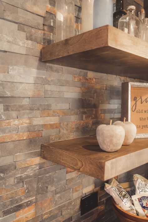 Obsessed with this basement bar... LOVE stack stone paired with floating shelves! #TeamGREEN  #GreenBasementsAndRemodeling #Basement #Bar #BasementBar #StackStone #ReclaimWood #RoswellRemodel #AtlantaConstruction #AlpharettaRemodel Stacked Stone Backsplash, Stacked Stone Walls, Floating Shelf Decor, Green Bar, Stone Bar, Stone Backsplash, Dry Bar, Basement Bar, Wood Burner