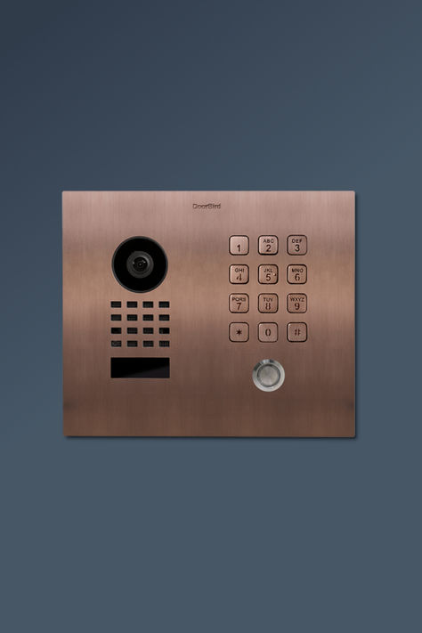 With its contemporary and minimalist design, the DoorBird D1101KH classic IP video door intercom in bronze adds a touch of elegance to any entrance while providing advanced security features. It is equipped with a convenient keypad for an additional layer of security and easy access control. Choose from more than 50 finishes and colors. Intercom System, Pvd Coating, Video Doorbell, Access Control, Bronze Finish, Single Family, Easy Access, Minimalist Design, Entrance