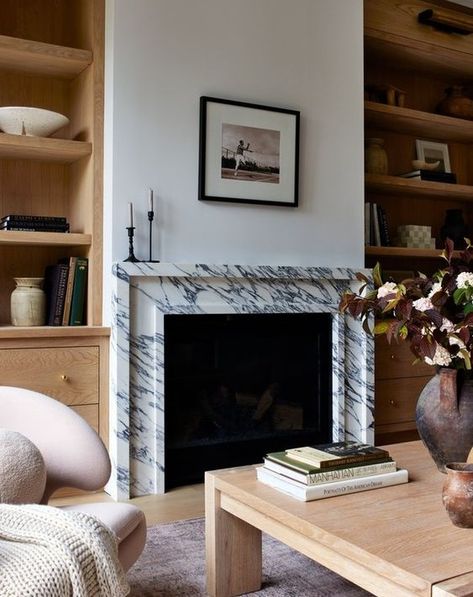 Completely in love with this chic living room! The stunning marble fireplace flanked by rich wood bookcases creates such a perfect balance. Wood and marble—my forever favorite combo! 🤍🔥 Design by @fisherhomela Photo by @jessicajalexander • • • • #LivingRoomGoals #WoodAndMarble #ChicInteriors #InteriorInspiration #DesignInspo #DesignLover #InteriorInspo #DesignDetails #HomeDesign #TimelessElegance Marble Fireplace Surround, Marble Fireplace, Chic Living Room, Modern Fireplace, Fireplace Wall, Humble Abode, Living Room With Fireplace, Fireplace Design, Fireplace Surrounds