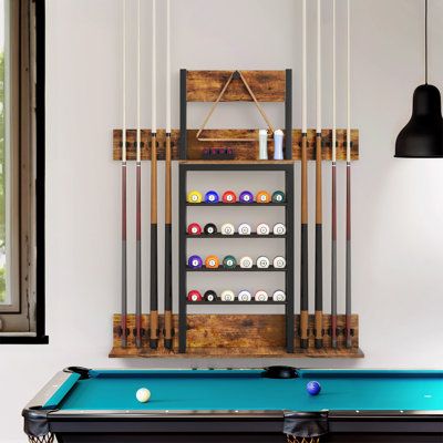 Organize your game room in style with our wall-mounted pool cue rack that can hold up to 8 cue sticks, featuring a built-in storage shelf for accessories, ample space for storing your pool balls, easy-to-clean design, sleek and minimalistic look that complements any home decor, and hassle-free installation. | Balconera 35.4 in | BLCG1678 | Wayfair Canada Pool Stick Holder, Pool Cue Rack, Pool Table Accessories, Pool Sticks, Stationary Storage, Cue Rack, Kitchen Furniture Storage, Billiard Accessories, Ball Storage