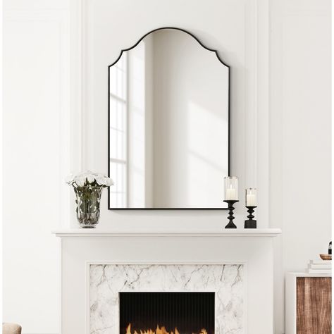 Showcase your modern, elevated aesthetic by hanging the Leanna wall mirror in your home. Inspired by the elegant curvature of sophisticated vintage art pieces, the Leanna features an arched shape with a scalloped edge on either side. Along this beautiful frame, you'll find a lovely satin black finish along with a slight bevel giving the mirror some added dimension. The overall dimensions of the Leanna wall mirror are 24 inches wide by 36 inches tall, making it a stellar statement piece for any wall in your home. Use the lovely Leanna mirror to elevate your living room, bedroom, entryway, or dining room. It captivates your guests as its own focal point or dazzles in a display of multiple mirrors. The ample surface area of this mirror allows it to spread vibrancy and dimension in your home w French Country Vanity, Arch Wall Mirror, Multiple Mirrors, Scalloped Mirror, Modern French Country, Modern Entry, Arch Wall, Kelly Clarkson Home, Mirror Metal