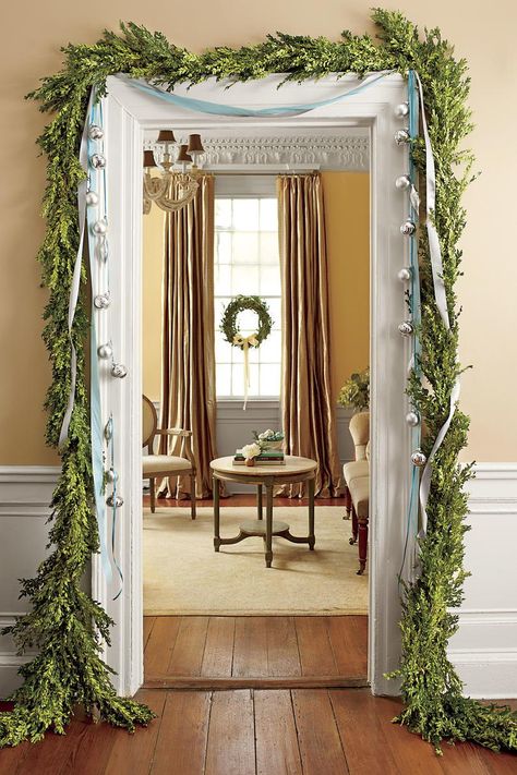 Simple Swag Dressed Up | A traditional boxwood garland is dressed up around the doorway with trailing ribbons and silver ornaments. Cut different lengths of ribbon, string the balls, and knot the lengths together before attaching to the door frame. #holiday #decor #southernliving Boxwood Garland, Fresh Christmas Wreath, Decorative Wreaths, Garland Ideas, Southern Christmas, Diy Christmas Garland, Holiday Greenery, Holiday Garlands, Christmas Bedroom