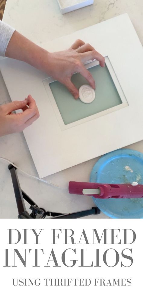 A photo of a hand holding an intaglio in the center of a photo mat with a hot glue gun next to it. How To Gild A Frame, Intaglios Framed Art, How To Frame Intaglios, Diy Painting Frames Ideas, Diy Vintage Framed Art, Diy Framed Intaglios, How To Sign Artwork, Vintage Art Diy, How To Make Intaglios