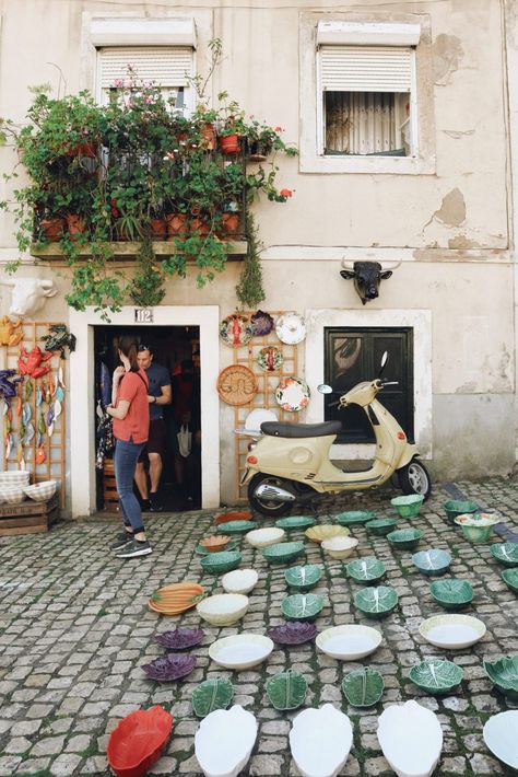 Lisbon's Alfama neighbourhood is one of the city's most picturesque areas. Rich in culture and history, Alfama is home to the infamous flea market and an array of quaint ceramic stores. Read our city guide online. Lisbon Cafe, Alfama Lisbon, Burgundy Walls, Unique Cafe, Ceramic Store, Port Area, Portuguese Culture, Word Pictures, Portugal Travel