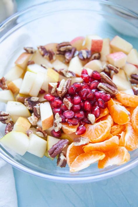 Thanksgiving fruit salad will be a colorful side dish for your holiday feast! With fall fruits, maple syrup and cinnamon, these seasonal flavors are a fresh and healthy addition to any Thanksgiving menu. Recipes With Mandarin Oranges, Thanksgiving Fruit Salad, California Salad, Mandarine Recipes, Salty Side Dish, Carrot Raisin Salad, Thanksgiving Fruit, Winter Fruit Salad, Dressing For Fruit Salad