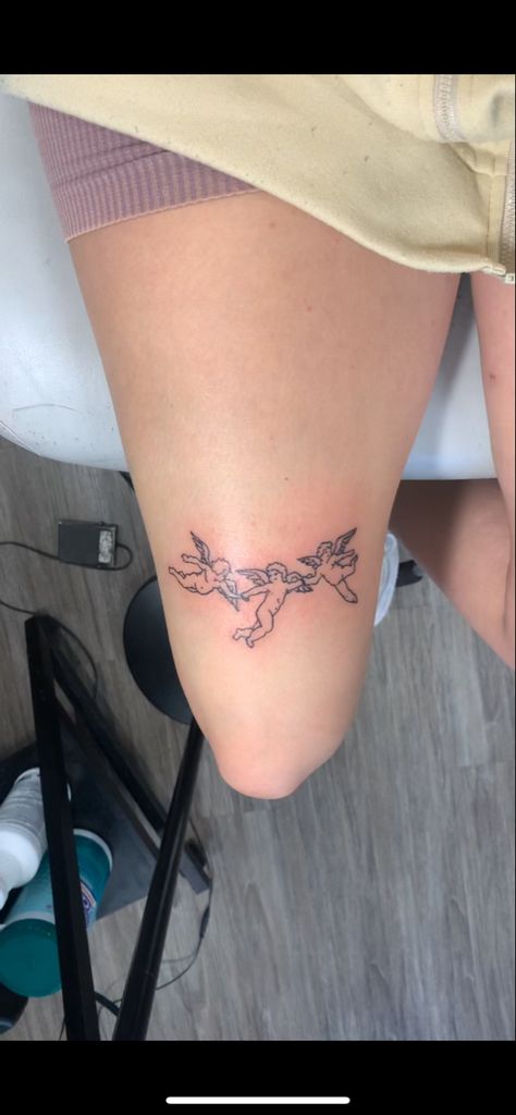 above the knee linework simple tattoo idea Angels Above Knee Tattoo, Mini Leg Tattoo, Above Tattoo Knee, Tattoo Above The Knee Women, Thigh Simple Tattoos Women, Leg Tattoos Linework, Women Leg Tattoo Ideas Small, Angel Above Knee Tattoo, Small Tattoos For Leg