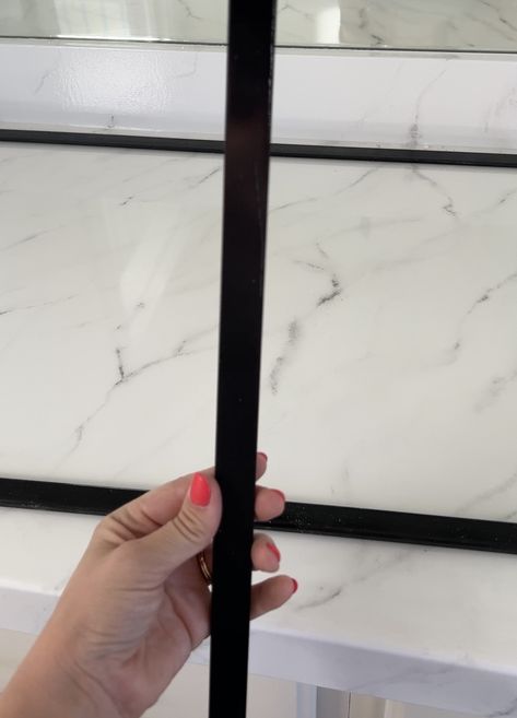 Trim On Bathroom Mirror, Bathroom Mirror Black Metal Frame, Tile Framed Bathroom Mirror, Frame Vanity Mirror Diy, Frameless Mirror Makeover, How To Put Trim Around Bathroom Mirror, Diy Vanity Mirror Frame, Modern Mirror Frame Diy, Black Bathroom Mirror Frame