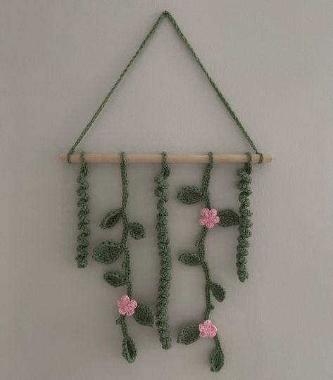 Crochet wall hanging of vines/leaves with flowers Crochet Vine Wall Decor, Room Decoration Crochet, Crochet Wall Decor Ideas, Crochet Vines And Leaves Pattern, Crochet Bedroom Decor, Crochet Vines, Wall Decor Crochet, Business Crochet, Crochet Wall Decor