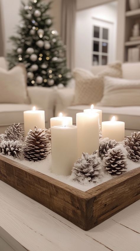 Wooden tray with white candles and snow-covered pine cones, enhancing a cozy living room's elegant winter decor for White Christmas Inspiration, Decor For Tables In Living Room, White Winter Christmas Decor, Living Room Filler Ideas, Gorgeous Christmas Decor, Winter Wonderland Home Decorations, Rustic Winter Decor Ideas For The Home After Christmas, Winter Themed Home Decor, Transition Christmas To Winter Decor