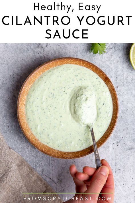 Close up of a hand holding a spoon in a bowl of creamy cilantro yogurt sauce. Sauce For Fish Tacos, Herb Ranch Dressing, Sauce For Fish, Healthy Biscuits, Healthy Tacos Salad, Lamb Kebabs, Cilantro Lime Sauce, Cilantro Sauce, Healthy Tacos