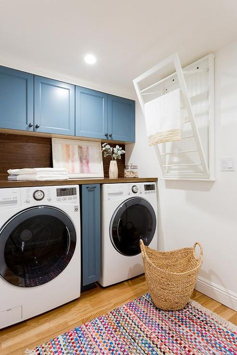 Pull down drying rack mounted on a wall in a transitional laundry room beside a white LG front load washer and dryer set. Pull Down Drying Rack, Wall Drying Rack, Laundry Room Drying Rack, Transitional Laundry Room, Pink Laundry Rooms, Pink Cabinets, Blue Laundry Rooms, Laundry Rack, Laundry Room Renovation