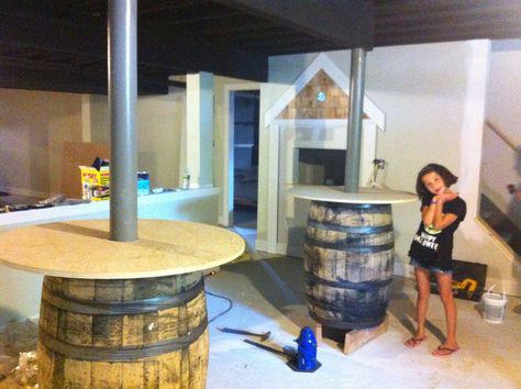 Wine barrels around columns!  My basement is coming along!! Cover Polls In Basement, Basement Poles, Wood Columns, Backyard Bar, Wine Barrels, Unfinished Basement, Basement Bar, Basement Decor, Whiskey Barrel