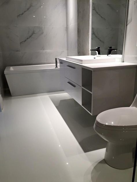 Remarkable how everything just ties in so beautifully with or super white epoxy in this modern bathroom. PurEpoxy. White Epoxy Bathroom Floor, White Epoxy Floors In Home, Epoxy Floor Bathroom, Epoxy Bathroom Floor, White Epoxy Floor, Epoxy Bathroom, White Flooring, Gray Vanity, Epoxy Flooring