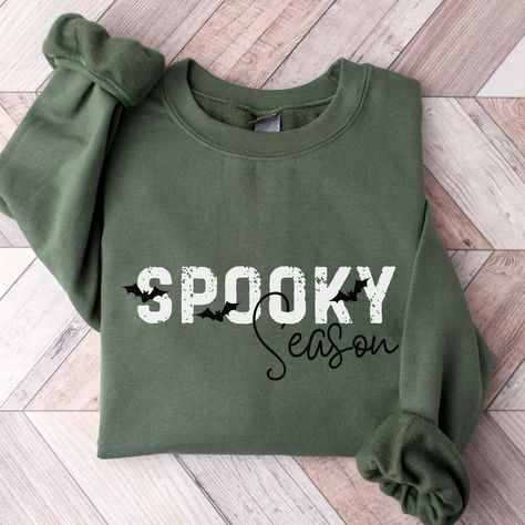 Celebrate Spooky Season in this simple Halloween bat sweatshirt for women. Ideal for any situation, a unisex heavy blend crewneck sweatshirt is pure comfort. These garments are made from polyester and cotton. This combination helps designs come out looking fresh and beautiful. The collar is ribbed knit, so it retains its shape even after washing. There are no itchy side seams on these sweaters.  .: Made with a medium-heavy fabric blend of 50% cotton and 50% polyester (8.0 oz/yd² (271.25 g/m this Fall And Halloween Shirt Ideas, Spooky Season Shirt, Halloween Sweatshirts Cricut, Diy Halloween Sweatshirt, Vinyl Sweatshirt Ideas, Fall Sweatshirt Ideas, Crucit Ideas, Bat Sweatshirt, Sweatshirt Sayings