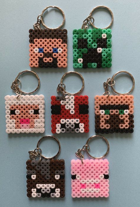 Minecraft Themed Handmade Hama Bead Keyrings  THESE ARE ALL NON OFFICIAL CHARACTER KEYRINGS. NO COPYRIGHT IS INTENDED A Fun Novelty Idea Based On A Minecraft Theme x1 Keyring -  Please Message Us With Which Design You Would Like x2 Keyrings - Please Message Us With Which Designs You Would Like x7 Keyrings -  Made Up Of  x1 Of Each - Steve, Pig, Mushroom Cow, Creeper, Sheep, Brown Cow & Villager x14 Keyrings - Made Up Of x2 Of Each -  Steve, Pig, Mushroom Cow, Creeper, Sheep, Brown Cow & Villager           If You Would Like A Different Mix Please Message Us                                                                                                                                            Not Suitable For Children under The Age Of 3 Years Old Imperfections May Arise as These Are Made T Hama Beads Keyring, Hama Bead Keyrings, Minecraft Melty Beads, Minecraft Pearl Beads, Pixel Beads Ideas, Small Hama Bead Designs, Pyssla Minecraft, Simple Perler Bead Patterns, Minecraft Handmade