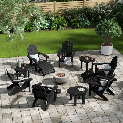 This 12-piece seating group lets you enjoy the warmth of the fire pit with your friends and family on a chilly night! It includes six classic Adirondack chairs, three side tables, and three ottomans, all made in the USA from recycled plastic. The durable chairs showcase a planked high back, slanted contoured seat, and two fixed arms. Three matching ottomans give you a place to kick up your feet and relax. And the end tables with slatted tops give you the perfect spot for a bowl of snacks or a gl Fire Pit Sphere, Outdoor Fire Pit Area, Unique Patios, Backyard Layout, Fireplace Cover, Outdoor Fireplaces, Fire Pit Seating, Fire Pit Cover, Diy Fire Pit