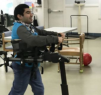 A teenager using the Rifton Pacer gait trainer to walk in a classroom. Gait Trainer, A Classroom, Floating Frame, Success Stories, Walk In, Stationary Bike, The Magic, Floating, Frame