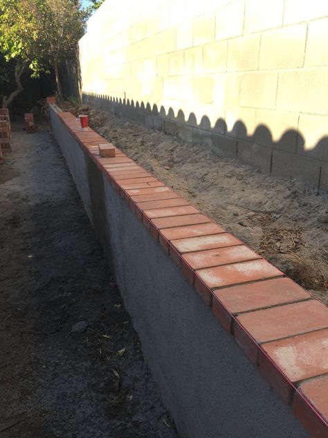 Decided to tie the new wall into the rest of the house by capping it with red brick. Poseidon Altar, Brick Border, Backyard Renovation, Knee Wall, Boundary Walls, Backyard Renovations, Red Brick House, Brick Veneer, Backyard Remodel