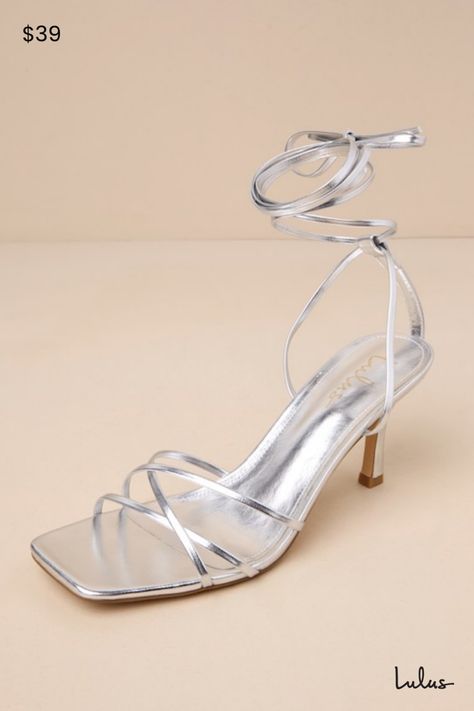 Make an entrance unlike any other with a fabulous look like the Lulus Lawrance Silver Lace-Up High Heel Sandals! Shiny faux leather shapes these trendy lil' heels that feature a classic square-toe footbed, a network of slender straps that create a peep-toe upper, and matching straps that weave through a supportive heel strap to wrap and tie above the ankle. 3. 25" wrapped stiletto heel. Cushioned insole. Rubber sole has nonskid markings. Man made materials. Imported. Lulus | Lawrance Silver Lace Chic Silver Strappy Heels, Silver Synthetic Heels With Wrapped Heel, Silver Heels For Summer Events, Silver Heels With Sculpted Heel In Synthetic Material, Silver Synthetic Heels With Sculpted Heel, Strappy Heels For Summer Events, Sleek Summer Heels For Party, Silver Sleek Heels For Summer, Silver Sleek Summer Heels