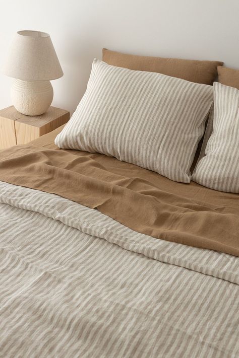 "This almond linen sheet set is everything you need to transform your bedroom into a comfortable, relaxing retreat. Durable and irresistibly soft, this linen sheets set includes one linen fitted sheet, one linen flat sheet, and two matching linen pillowcases that are pre-washed for a cozy lived-in look. And the best part is that our linen bedding will delight in breathability, natural moisture-wicking and temperature-regulating properties that will keep your sleep environment fresh and comfy all year round.  DETAILS - Set includes: 1x fitted sheet, 1x flat sheet, and 2x linen pillowcases - Handmade from high-quality European linen (certified free from harmful chemicals) - Fitted sheet features a continuous elastic hem - Pillowcases feature an envelope closure - No seams in the middle - Pre Organic Cotton Sheets Bedding, Bed Linen Color Combos, White Linen Bedding Aesthetic, Simple Bedding Comforters, Simple Bedding King, Striped Bed Linen, Boho Bed Linen, Beige Interior Bedroom, H&m Bedroom