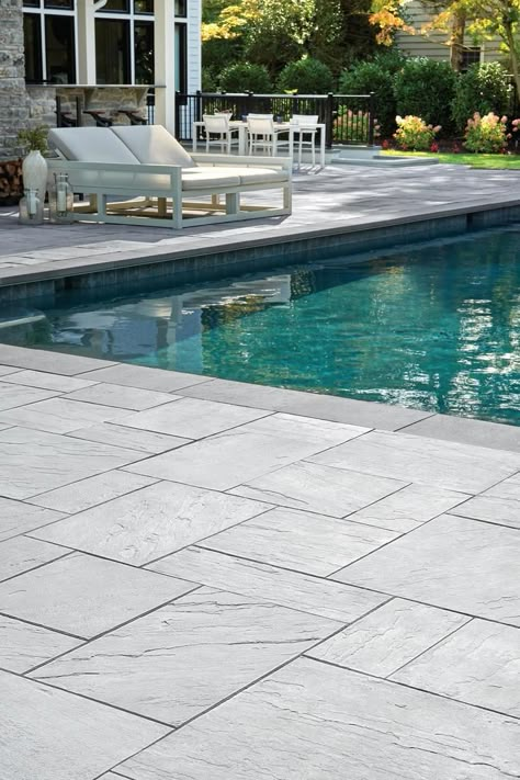 Make a spalsh this summer with our poolside landscaping ideas! Concrete Patio Tiles, Pool Patio Pavers, Pool Flooring, Stamped Concrete Pool Deck, Pool Paving, Inground Pool Landscaping, Pool Pavers, Pool Decking, Florida Pool