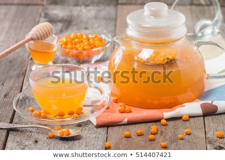 Tea with sea buckthorn and honey on wooden background Transparent Teapot, Sea Buckthorn Tea, Fruit Health Benefits, Stone Background, Fruit Benefits, Glass Teapot, Sea Buckthorn, Wooden Background, Hot Drinks