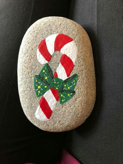 Candy cane holiday Christmas  painted rock from Columbus IN rocks Christmas Paintings Rocks, Painted Rocks Ideas Christmas, Painted Stones Christmas, Candy Cane Rock Painting, Painted Candy Canes, Rock Painting For Christmas, Easy Christmas Rocks To Paint, Easy Christmas Rock Painting, Painted Rocks Christmas Easy