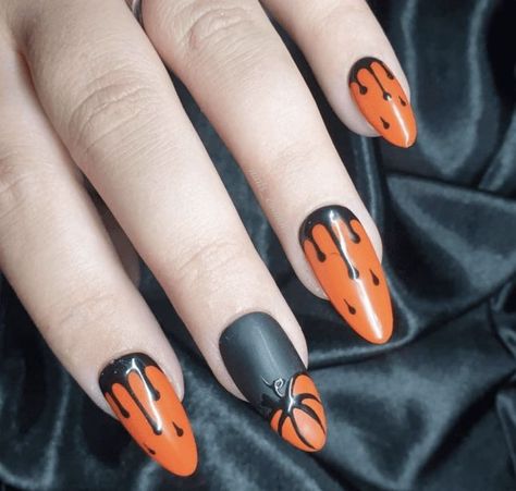 These almond-shaped nails feature a bold Halloween design with orange and black colors. The nails are decorated with black dripping patterns on an orange base, creating a dramatic effect. One nail showcases a matte black base with an orange pumpkin accent, adding a festive touch. Classy Black Nails, Black Halloween Nails, Bright Nail Art, Metallic Nail Art, Themed Nails, Orange Nail Designs, Nail Tip Designs, Halloween Nails Easy, Halloween Beauty