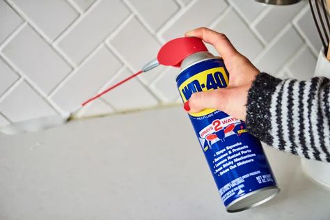 9 Surprising Uses for a Can of WD-40 | Apartment Therapy Gardening Tool Handles, Squeaky Door Hinges, Wd 40 Uses, Remove Sticky Residue, Squeaky Door, Remove Oil Stains, Dawn Dish Soap, Grease Stains, Wd 40