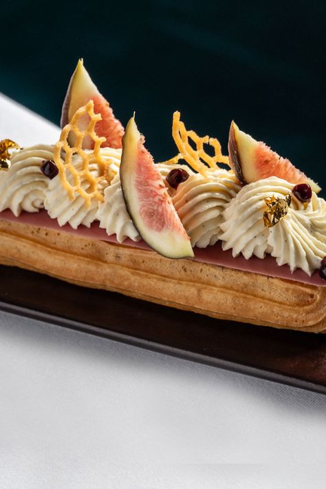 This elegant éclair from Sarah Frankland is filled with a lightly sweetened fig crémeux and garnished with blackcurrant gel, fresh figs, and gold leaf. The ganache needs to chill overnight, so be sure to start well in advance. Eclairs Aesthetic, Dessert Fine Dining, Fine Desserts, Fig Dessert, Eclairs Dessert, Eclair Recipe, Fine Dining Desserts, Plating Ideas, British Desserts