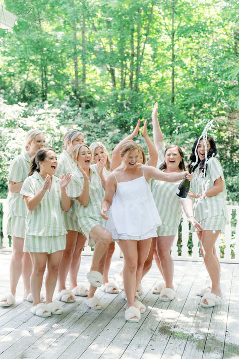 Bridesmaids popping champagne in chic, green striped bridal party pajamas and slippers #bridalpartypajamas #bridesmaidpajamas #bridepajamas #bridalpartypjs #greenpajamas Popping Champagne, Party Pajamas, Bridal Party Pajamas, Highlands Nc, Bridesmaid Pyjamas, Green Bridesmaid, Summer Destinations, Wedding Bridal Party, Pastel Wedding