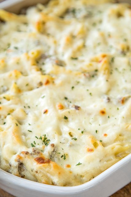 Three Cheese Italian Sausage Alfredo Bake - great make-ahead pasta dish. Elbow macaroni, alfredo sauce, sour cream, ricotta, garlic, italian sausage, eggs, parmesan and mozzarella cheese. SO good!! We make this at least once a month! Can freeze half for later. This is THE BEST pasta casserole we've ever eaten!!! #casserole #freezermeal #pasta #pastacasserole Macaroni Alfredo, Italian Sausage Alfredo, Sausage Alfredo Bake, Ground Italian Sausage Recipes, Sausage Alfredo Pasta, Baked Pasta Casserole, Sausage Alfredo, Pasta Sausage, Alfredo Bake