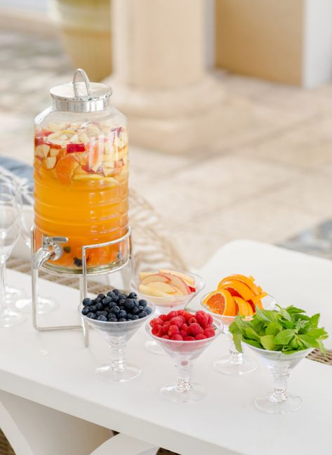 Lately I have been trying to make more creative cocktail stations for my parties so when I hosted a Mom’s Night Out at my house last week I created this sweet Sangria Bar with a yummy selection of toppings for everyone to garnish their drinks. Key elements to this display are a fun drink dispenser {I got this one at West Elm. It’s... Diy Sangria Bar, Diy Sangria, Sangria Bar, Food Display Table, Cocktail Station, Fashionable Hostess, Drink Garnishing, Cocktail Garnish, Party Tips