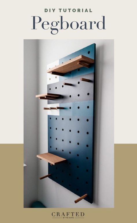 This DIY pegboard is spray painted with a fun geometric design to give it a modern look. Add a pegboard to a bedroom, office, craft room, kids space, or home gym. The options are limitless! Pegboard Partition, Pegboard Color Ideas, Peg Board Office Ideas, Pegboard Gear Wall, Cool Pegboard Ideas, Wood Pegboard Wall, Diy Giant Pegboard, Creative Pegboard Ideas, Pegboard Mudroom Entryway