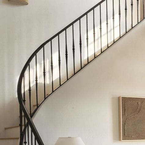 Kelsey | Interior Design Studio on Instagram: "The focal point of the Black Oak entryway is a captivating curved staircase adorned with a custom iron rail featuring iron spoon details. My vision for the home was to infuse it with character and texture, and the staircase delivers just that. The combination of old and new elements in the design gives the house a timeless appeal while still feeling intentionally designed for a modern family.⁠ ⁠ See the full reveal on the KLD blog - link in bio!⁠ ⁠ Designer: @kelseyleighdesignco⁠ Builder: @mcgregorhomes⁠ Photography: @emilyhartphoto⁠ Furnishing: @kldheritagehouse⁠" Spanish Revival Staircase, Black Iron Stair Railing, Black Iron Railing, French Staircase, Tree Stairs, Iron Staircase Railing, Modern French Provincial, Modern Provincial, Foyer Stairs