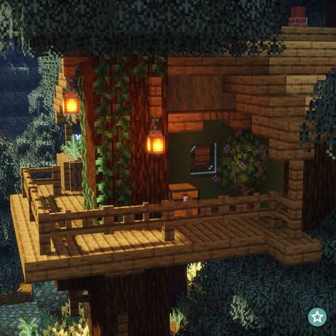 A one-story Treehouse in the game Minecraft supported by six individual trees. It is located in a dense Northern Forest. The frame is mainly made out of Spruce Wood. The walls have a dark green finish which matches perfectly with the leaves of the trees. There are two balcony's, one located in the front and the other located on the left side of the house. Beneath the treehouse there are some crop fields. Treehouse In Minecraft, Minecraft Treehouses, Minecraft Tree, Minecraft Aesthetic, Minecraft Interior Design, Minecraft House Plans, Minecraft Farm, Minecraft Cottage, Diy Minecraft