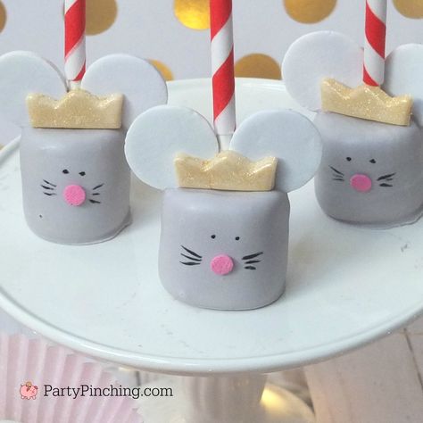 These Mouse King Marshmallow Pops are so easy to make and perfect for your Christmas Nutcracker Ballet theme party! You will need: marshmallows white candy melts black candy melts Necco wafer candies white fondant gold food color spray pink confetti sprinkles black edible marker lollipop sticks Melt a bag of white candy coating and about...Read More » Mouse Party Ideas Mice, Nutcracker Themed Treats, Nutcracker Ballet Birthday Cake, The Nutcracker Birthday Party, Nutcracker Cake Pops, Nutcracker Treats, Nutcracker Tea Party, Nutcracker Birthday Party, Nutcracker Ballet Party