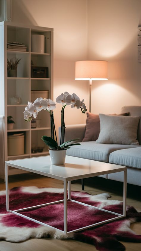 Elevate your living space with a touch of nature! This cozy living room features elegant orchids on a minimalist coffee table, perfectly complementing the sleek white KALLAX shelving unit and soft EKTORP sofa. The vibrant RENS sheepskin rug adds personality, while warm lighting from the NOT floor lamp creates an inviting atmosphere. Discover how to style your own space with these chic elements and make it a relaxing retreat. Click for more inspiration! #IKEAStyle #LivingRoomDecor #Orchids #CozyHome #InteriorDesign #MinimalistLiving #HomeStyling Room Oasis, Ikea Style, Kallax Shelving, Kallax Shelving Unit, Ektorp Sofa, Minimalist Coffee, Minimalist Coffee Table, Warm Lighting, My Space