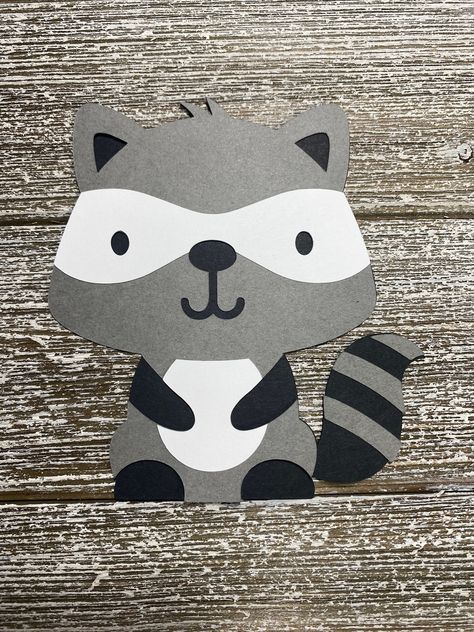 Super cute raccoon cutout. Great for birthdays, baby showers, diaper cakes, cake toppers, banners, decorations, etc. Size : Choose from 4, 5, 6 inches tall (actual size: 4in W x 4in H, 5.1in W x 5in H, 6.1in W x 6in H) Colors: Black White Gray **Message for different color combinations or sizes not listed above.  Glitter cardstock is also available for an additional cost and a pick can be added to the cutout to insert in cake/ or diaper cake for $0.25 each, message me for a custom order to inclu Raccoon Baby Shower Ideas, Whale Cutout, Door Decs, Woodland Fox, How To Make Banners, Cute Raccoon, Diaper Cakes, Racoon, Cute Fox