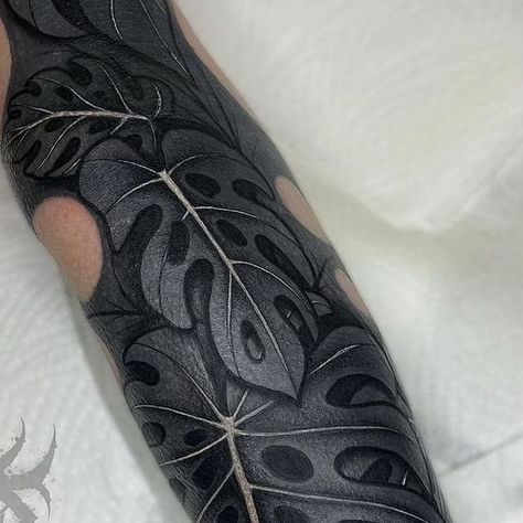 Black Tattoo With White Ink On Top, Black Monstera Tattoo, White On Black Tattoo Cover Up, Dark Leaf Tattoo, Black Out Tattoo With White Ink, Black Leaf Tattoo, Heavy Black Tattoo, Black Arm Tattoo, White On Black Tattoo