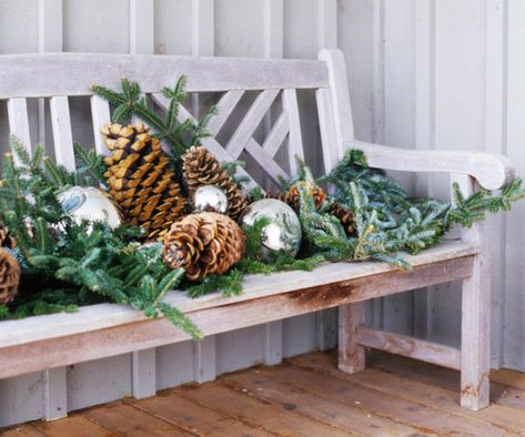 entryway bench covered with branches from the xmas tree, oversize silver ornaments, collection of huge pinecones Simple Holiday Decor, Holiday Greenery, Christmas Porch Decor, Fun Christmas Decorations, Outdoor Holidays, Outdoor Holiday Decor, Outdoor Christmas Lights, Christmas Porch, Noel Christmas