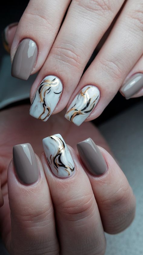 Discover the ultimate in chic nail art with this stunning taupe base featuring a sophisticated marble effect in soft white and subtle black accents. Enhanced with luxurious metallic gold swirls, this design embodies elegance and versatility, making it perfect for both casual outings and special events. Whether you're sipping coffee with friends or attending a glamorous evening affair, these nails are sure to make a statement. #nailsdesign #acrylicnails #septembernails #fallnails #autumnnails Marble Nails With Gold, Taupe Nails, Nails With Gold, Chic Nail Art, September Nails, Sipping Coffee, Coffee With Friends, Casual Nails, Elegant Casual