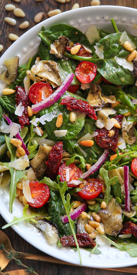 Healthy Italian Salad: a mix of baby Spinach + Arugula, Sun-Dried Tomatoes, Artichokes, Cherry Tomatoes, Pine Nuts, Parmesan - on a white plate. Artichoke Spinach Salad, Healthy Italian Salad, Vegan Salad Bowl, Vegan Drinks Healthy, Baby Spinach Salad, Pine Nuts Salad, Baby Spinach Salads, Italian Salad Recipes, Arugula Salad Recipes