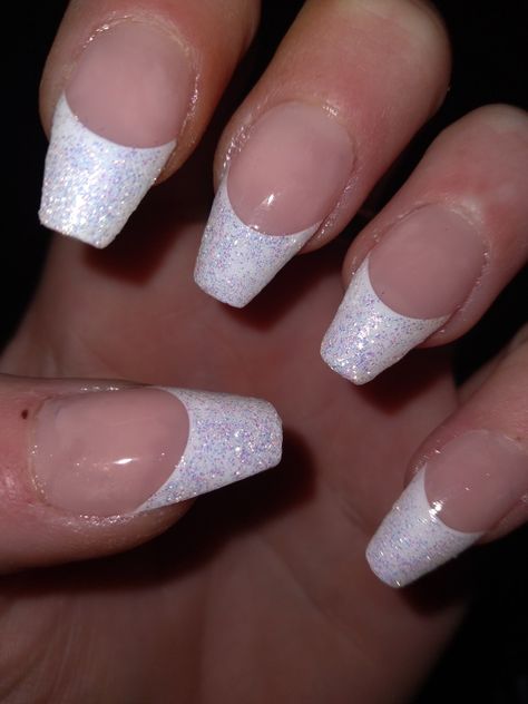 The photo only shows one hand but All 10 of my nails are coffin style. Each have a beautiful, shimmery white French tip topped off with a nice clear glossy top coat. Glitter French Tip With Rhinestones, Sparkly French Tips Coffin, White Nail Silver Tip, White French Glitter Nails, Glitter French Tips Coffin, White Sparkle French Tip, Glittery White French Tip Nails, French Tip Sparkly Nails, Shimmer French Nails