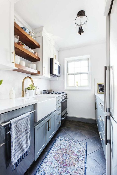 A dark galley kitchen transforms thanks to two-tone cabinets, open shelving, and mixed metal hardware. Dark Galley Kitchen, Galley Kitchen Renovation, Galley Kitchen Layout, Small Galley Kitchen, Galley Kitchen Design, Kitchen Layouts, Galley Kitchen Remodel, Galley Kitchens, Gray Cabinets