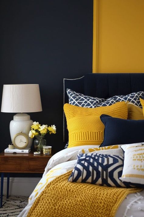 25 Yellow Bedroom Ideas That Will Give Your Space a Major Energy Boost Navy And Yellow Bedroom, Yellow And Blue Bedroom, Grey Colour Scheme Bedroom, Mustard Bedroom, Grey Bedroom Colors, Yellow Bedroom Ideas, Wrought Iron Headboard, Yellow Bedspread, Navy Accent Walls