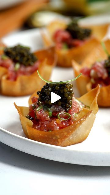 Nadia Aidi on Instagram: "Truffled Bluefin Tartare Wonton Cups & Caviar ✨ truly one of my favorite apps! So easy to make ahead and everyone ALWAYS goes crazy for it.   Do you have any appetizer requests? Tell me about your event and I’ll create something for you!  Ingredients: * 12 wonton wrappers. * 8-10 oz bluefin tuna. * 4 scallions (green part only). * 1.5 tbsp creme fraiche. * 1 tbsp tamari or soy sauce. * 1 lemon (zest). * 1/2-1 tsp black truffe oil. * Salt and pepper to taste. * Caviar to taste.  Directions: 1. Make a small x in the middle of the wonton wrappers so they don’t puff up. 2. Spray a muffin tin with oil, press in the wonton wrappers and spray more oil on top. 3. Bake at 350F for 10-12 min or until golden. 4. Chop your tuna pretty finely. 5. Add to a bowl with the creme f Recipes With Wonton Wrappers, Wonton Cups Appetizers, Caviar Appetizers, Wonton Wrapper Recipes, Wonton Cups, Bluefin Tuna, Seared Tuna, Wonton Wrappers, Truffle Oil