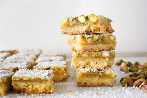 These easy lemon bars have everything the traditional ones do – tang, sweetness and a butter-y rich base – plus the added benefit of pistachios folded into the filling and the crust They're just delightful. Lemon Pistachio, Lemon Bars Easy, Lemon Bars Recipe, Best Christmas Cookies, Nyt Cooking, Lemon Bars, Salted Butter, Favorite Desserts, Bars Recipes