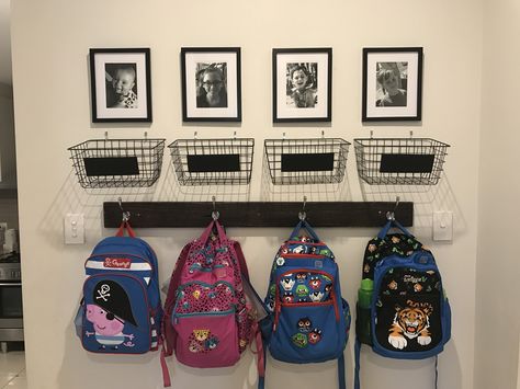 School bag storage. Baskets from Kmart for school notes and a photo above each hook! Total cost $50! Backpack Station, Bag Storage Ideas, School Bag Storage, Home Command Center, School Storage, Home Daycare, Storage House, Organization Kids, Home Organisation